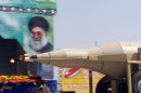 A truck carries a Sejil missile past a large portrait of Ayatollah Ali Khamenei in Tehran, on September 22, 2013