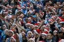Marseille supporters wearing Santa Claus hats, shout slogans, during the League One soccer match between Marseille and Lille, at the Velodrome Stadium, in Marseille, southern France, Sunday, Dec. 21, 2014. (AP Photo/Claude Paris)