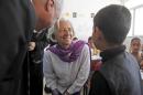 Christine Lagarde, International Monetary Fund Managing Director, speaks to Syrian refugee student at Alimate school in Mafraq in this file photo