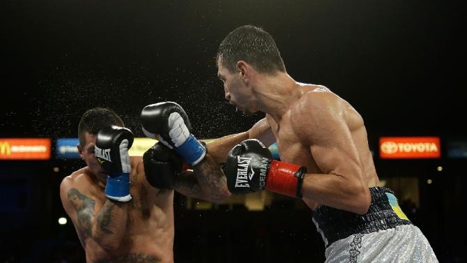 Viktor Postol of the Ukraine throws a right hand at Lucas Matthysse of Argentina at StubHub Center on October 3, 2015 in Carson, California
