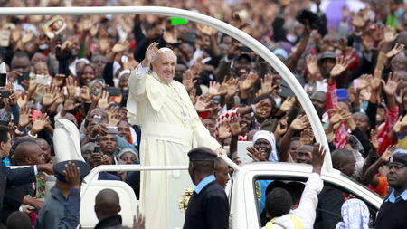 Pope Francis waves to the faithful as he arrives for a Papal mass in Kenya's capital Nairobi
