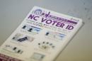 A pile of government pamphlets explaining North Carolina's controversial "Voter ID" law sits on table as the law goes into effect for the state's presidential primary in Charlotte