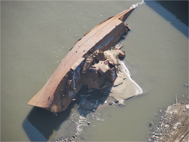 This Nov. 28, 2012 photo provided by The United States Coast Guard shows a WWII minesweeper on the Mississippi River near St. Louis, Mo. The lack of rain has left many rivers at low levels unseen for decades offering a glimpse at things not normally seen. The minesweeper, once moored along the Mississippi River as a museum at St. Louis before it was torn away by floodwaters two decades ago, has become visible _ rusted but intact. (AP Photo/United States Coast Guard, Colby Buchanan)