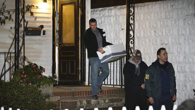 FILE - In a Thursday, Oct. 10, 2013 file photo, FBI agents remove evidence from the Brooklyn residence of Rabbi Mendel Epstein during an investigation, in New York. Several defendants, including Epstein and another rabbi, are accused by the FBI of plotting to kidnap and beat a man to force him to grant a religious divorce. Epstein’s trial starts Tuesday, Feb. 17, 2015, in federal court in New Jersey. Several co-defendants have pleaded guilty and others will join him in court this week.  (AP Photo/John Minchillo, File)