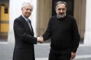 Italian PM Mario Monti shakes hands with Fiat-Chrysler CEO Marchionne during a meeting at Chigi palace in Rome
