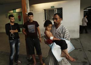 A Palestinian man taking shelter at a UN school carries&nbsp;&hellip;