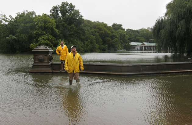 Jimmy Kaplow, left, and David Korostoff, both of New York, step through standing water at the Bethesda Fountain area in New York's Central Park as Tropical Storm Irene passes through the city, Sunday,