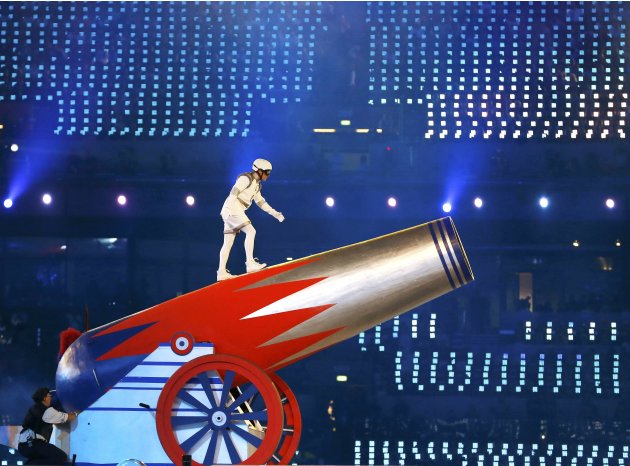A performer prepares to climb into a giant cannon at the closing ceremony of the London 2012 Olympic Games at the Olympic Stadium