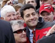 Republican vice presidential candidate, Rep. Paul Ryan, R-Wis. poses with supporters after speaking at a campaign rally at the Valley View Campgrounds in Belmont, Ohio, Saturday, Oct. 20, 2012, where he talked about economic conditions and the coal industry. (AP Photo/Keith Srakocic)