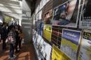 People look at photos of the Occupy Central civil disobedience movement displayed inside the campus of the University of Hong Kong