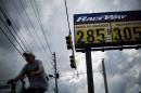 In this Wednesday, Oct. 29, 2014 photo, gas station prices are posted for passing motorists in Augusta, Ga. The U.S. is on track for the lowest annual average gas price since 2010 _ and the 2015 average is expected to be lower even still. (AP Photo/David Goldman)