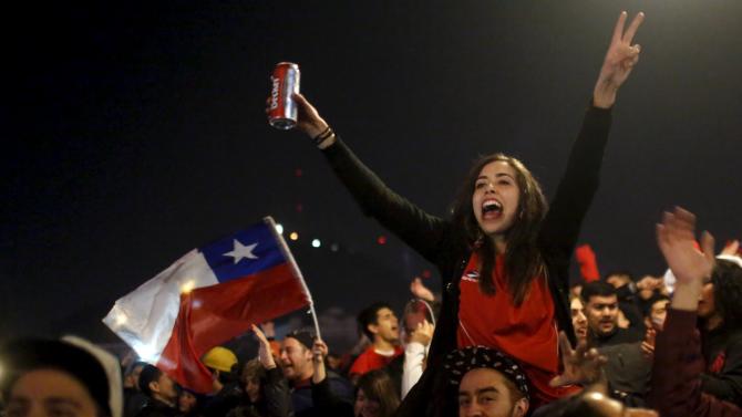 Fans celebrate after Chile&#39;s victory over Uruguay in their Copa America 2015 quarter-finals soccer match in Santiago