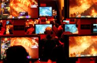 Computer gamers play in front of their screens on August 17, 2011, during the Gamescom fair in Cologne.