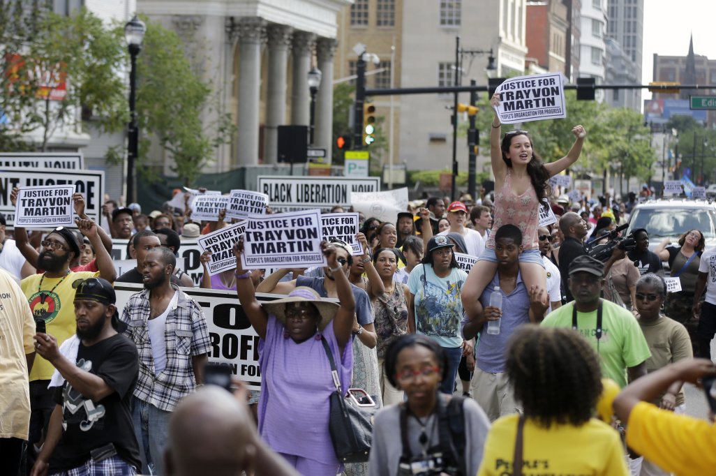 A large crowd marches along Broad Street, Sunday, July 14, 2013, in Newark, N.J., to protest the acquittal in George Zimmerman's murder trial. Organizers said the outdoor protest staged Sunday drew a diverse crowd unhappy with a Florida jury's decision to clear the former neighborhood watch volunteer in the shooting death of 17-year-old Trayvon Martin. (AP Photo/Mel Evans)