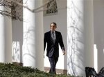 U.S. President Barack Obama walks through the colonnade of the White House in Washington
