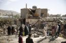 People gather at the site of a house destroyed by a Saudi-led airstrike in Sanaa, Yemen, Thursday, Feb. 25, 2016. (AP Photo/Hani Mohammed)