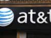 FILE-This May 6, 2012, file photo, shows an AT&T sign at a store in New York. Following in Verizon's footsteps, AT&T said Wednesday, July 18, 2012, it will introduce wireless plans that let subscribers connect up to ten devices. Connected phones get unlimited calling and texting, and all devices get wireless data access. The devices tap into a limited pool of data usage, which get renewed each month.  (AP Photo/CX Matiash, File)