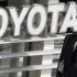 A security officer walks round a Toyota showroom in Tokyo, Tuesday, Feb. 5, 2013.  Toyota Motor Corp. reported its October-December profit rose 23 percent to 99.91 billion yen ($1.09 billion), compared to the same period the previous year, as sales jumped, especially in the U.S. Toyota also raised its projections Tuesday for the fiscal year through March.  (AP Photo/Koji Sasahara)