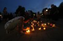 People in Gatineau collect candles at the conclusion of a vigil for the victims of the fatal train disaster in Lac-Megantic