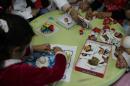 Young girls play puzzles as an occupational therapist assesses their cognitive development inside a Medecins Sans Frontieres hospital in Amman