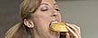 woman eating donuts (thinkstock)