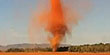 Dust devil rises from a dry field. (Yahoo! Videos)