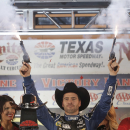 Jimmie Johnson fires pistols to celebrate winning the NASCAR Sprint Cup series auto race at Texas Motor Speedway in Fort Worth, Texas, Sunday, Nov. 3, 2013. (AP Photo/Brandon Wade)