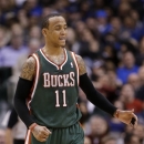 Milwaukee Bucks' Monta Ellis (11) smiles as he returns to the bench after scoring in the second half of an NBA basketball game against the Dallas Mavericks on Tuesday, Feb. 26, 2013, in Dallas. Ellis scored 22 points, and the Bucks spoiled Dirk Nowitzki's first game in nearly 10 years with at least 20 points and 20 rebounds with a 95-90 victory. (AP Photo/Tony Gutierrez)