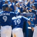 Toronto Blue Jays third baseman Mark DeRosa, right, celebrates his three-run home run with teammates J.P. Arencibia, left, and Jose Bautista while playing against the Seattle Mariners during fifth inning MLB American League baseball action in Toronto on Sunday, May 5, 2013. (AP Photo/THE CANADIAN PRESS,Nathan Denette)