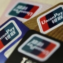 Logos of China UnionPay are seen on bank cards in this photo illustration taken in Beijing December 5, 2013. REUTERS/Barry Huang