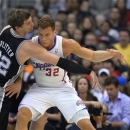 San Antonio Spurs center Tiago Splitter, left, of Brazil, knocks the ball from the hands of Los Angeles Clippers forward Blake Griffin during the first half of an NBA basketball game, Thursday, Feb. 21, 2013, in Los Angeles. (AP Photo/Mark J. Terrill)