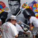 Employees of Joe's Pizza build a makeshift memorial to the late Muhammad Ali near a mural in New York. REUTERS/Lucas Jackson