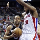 San Antonio Spur guard Tony Parker,left, goes to the basket against Detroit Pistons center Greg Monroe (10) in the first half of an NBA basketball game Friday, Feb. 8, 2013, in Auburn Hills, Mich. (AP Photo/Duane Burleson)