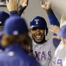 Texas Rangers' Elvis Andrus is greeted in the dugout after he scored in the third inning of a baseball game against the Seattle Mariners, Tuesday, May 22, 2012, in Seattle. (AP Photo/Ted S. Warren)