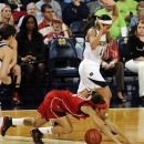 Louisville guard Bria Smith, bottom, is tripped up by Notre Dame guard Skylar Diggins in the first half of an NCAA college basketball game, Monday, Feb. 11, 2013, in South Bend, Ind. (AP Photo/Joe Raymond)