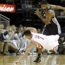 Rockets Jeremy Lin (7) scrambles for the ball against Spurs Tim Duncan (21) during the first half of an NBA basketball game, Sunday, Oct. 14, 2012, in Houston. (AP Photo/Eric Kayne)