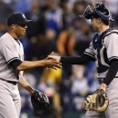 New York Yankees relief pitcher Mariano Rivera, left, is congratulated by catcher Chris Stewart following the Yankees' 3-2 win in a baseball game against the Kansas City Royals at Kauffman Stadium in Kansas City, Mo., Saturday, May 11, 2013. (AP Photo/Orlin Wagner)