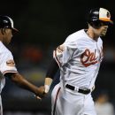 Baltimore Orioles' Matt Wieters, right, is greeted by third base coach DeMarlo Hale (45) after he hit a three-run home run against the New York Yankees during the first inning of a baseball game, Thursday, Sept. 6, 2012, in Baltimore. (AP Photo/Nick Wass)