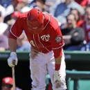Washington Nationals' Bryce Harper grabs his knee as he steps out of the batter's box while batting during the third inning of a baseball game against the Philadelphia Phillies at Nationals Park, Sunday, May 26, 2013, in Washington. (AP Photo/Alex Brandon)