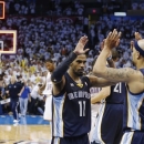 Memphis Grizzlies point guard Mike Conley (11) and Jerryd Bayless (7) celebrate at the end of Game 5 of their Western Conference Semifinals NBA basketball playoff series against the Oklahoma City Thunder in Oklahoma City, Wednesday, May 15, 2013. Memphis won 88-84. (AP Photo/Sue Ogrocki)