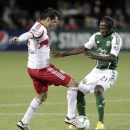 New York Red Bulls forward Fabian Espindola, left, and Portland Timbers midfielder Diego Chara battle over the ball during the second half of an MLS soccer game in Portland, Ore., Sunday, March 3, 2013. Portland and New York tied 3-3.(AP Photo/Don Ryan)