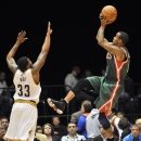 Milwaukee Bucks guard Monta Ellis, right, shoots over Cleveland Cavaliers guard Alonzo Gee during the first quarter of a preseason NBA basketball game, Tuesday, Oct. 9, 2012, in Canton, Ohio. (AP Photo/David Richard)