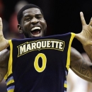 Marquette forward Jamil Wilson (0) celebrates their 71-61 win over Miami in an East Regional semifinal in the NCAA college basketball tournament, Thursday, March 28, 2013, in Washington. Wilson scored 16 points in the victory. (AP Photo/Mark Tenally)