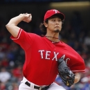 Texas Rangers starting pitcher Yu Darvish (11) of Japan throws against the Los Angeles Angels during the first inning of game one of a baseball double header Sunday, Sept. 30, 2012, in Arlington, Texas. (AP Photo/LM Otero)