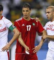 Morocco's Marouane Chamakh, center, make his way past Tunisia's captain Karim Haggui, left and Aymen Abdennour during their African Cup of Nations Group C soccer match at Stade De L'Amitie in Libreville, Gabon, Monday, Jan. 23, 2012.