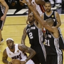 Miami Heat small forward LeBron James (6) looks to pass against San Antonio Spurs small forward Kawhi Leonard (2) and San Antonio Spurs power forward Tim Duncan (21) during the second half of Game 2 of the NBA Finals basketball game, Sunday, June 9, 2013 in Miami. (AP Photo/Wilfredo Lee)