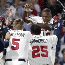 Atlanta Braves' Justin Upton, top right, is doused by teammates as he crosses home plate after hitting a walkoff home run during the ninth inning of a baseball game against the Chicago Cubs, Saturday, April 6, 2013, in Atlanta. Atlanta won 6-5. (AP Photo/Butch Dill)