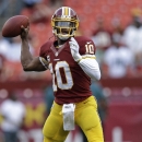 Washington Redskins quarterback Robert Griffin III warms up before an NFL football game against the Philadelphia Eagles in Landover, Md., Monday, Sept. 9, 2013. (AP Photo/Patrick Semansky)