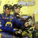 NASCAR Chase drivers Martin Truex Jr., left, and Kurt Busch, right, celebrate their making the Chase after the NASCAR Sprint Cup Series auto race at Richmond International Raceway in Richmond, Va., early Sunday, Sept. 8, 2013. (AP Photo/Jason Hirschfeld)