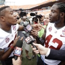Alabama's Eddie Lacy interviews Christion Jones during Media Day for the BCS National Championship college football game Saturday, Jan. 5, 2013, in Miami. Alabama faces Notre Dame in Monday's championship game. (AP Photo/David J. Phillip)